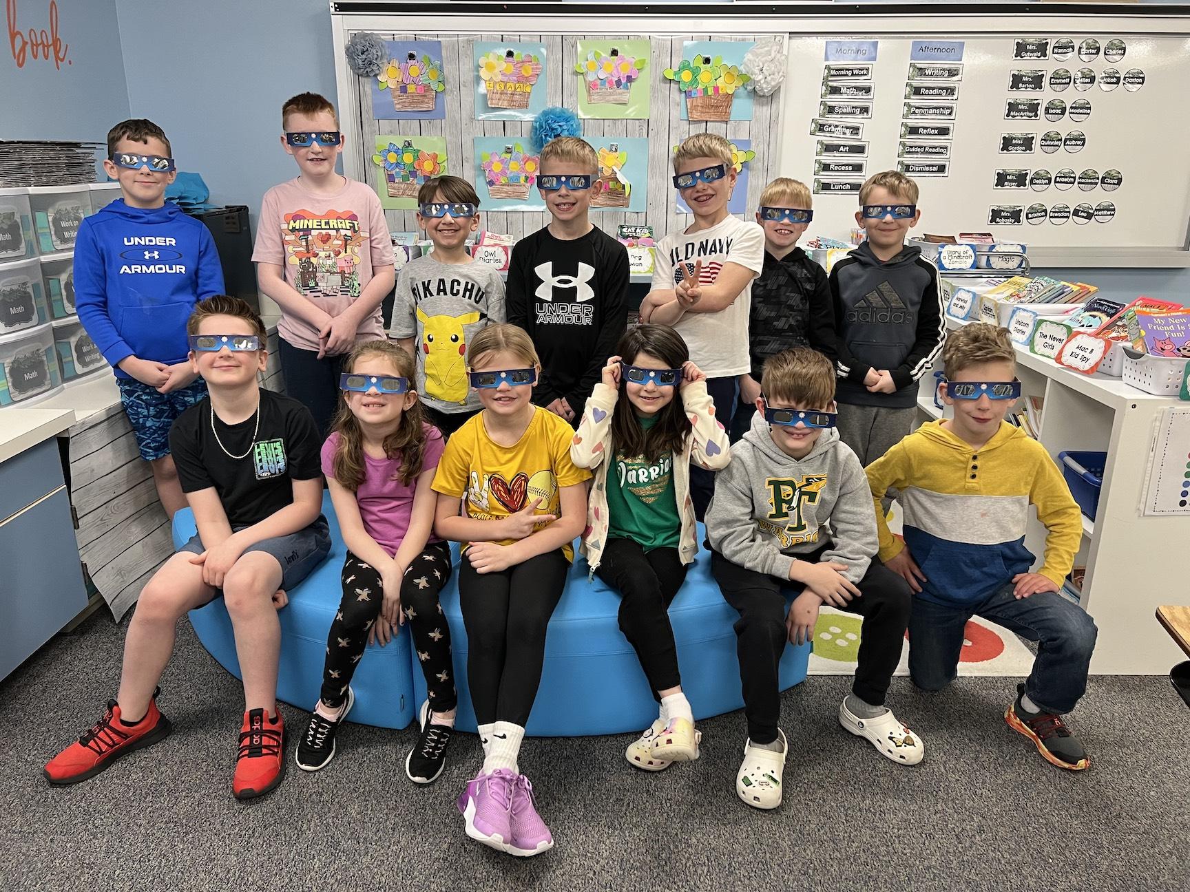 Mrs. MacArthur’s 2nd-grade class shows off their solar eclipse glasses