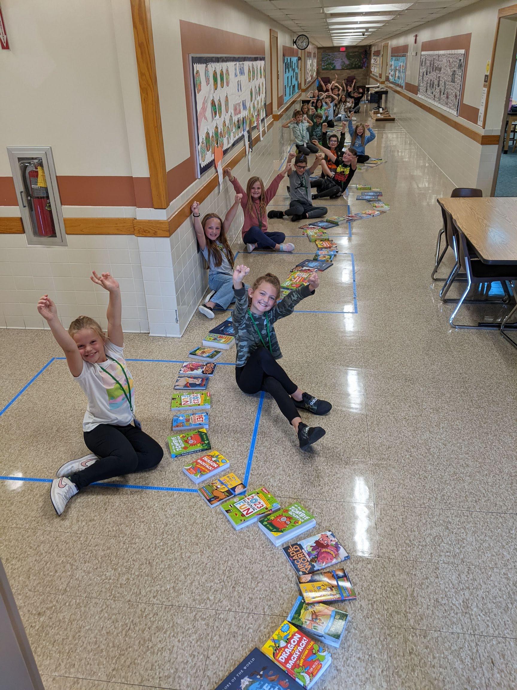 Mrs. Oliver’s 3rd-graders show off the large number of books they received
