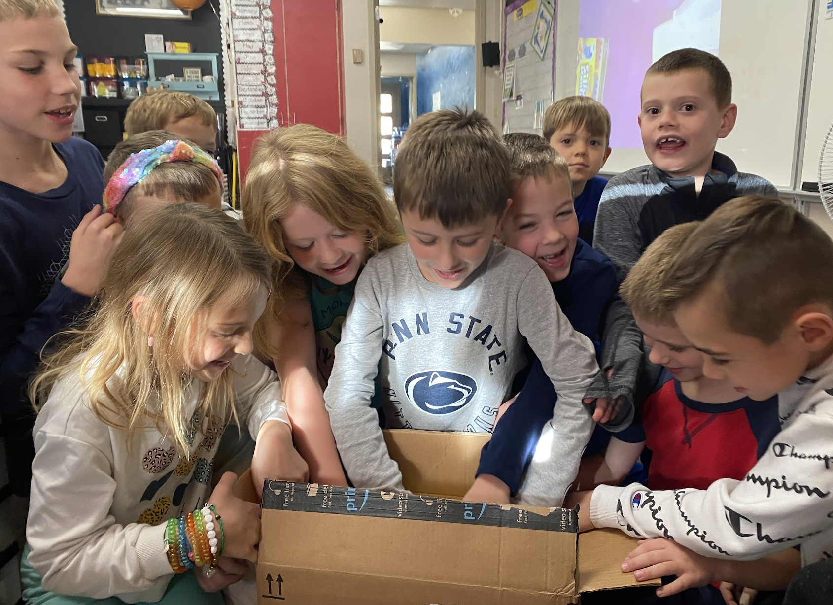 Mrs. Konopka’s students at McCullough Elementary School unbox the new literacy games which were made possible through the anonymous donation