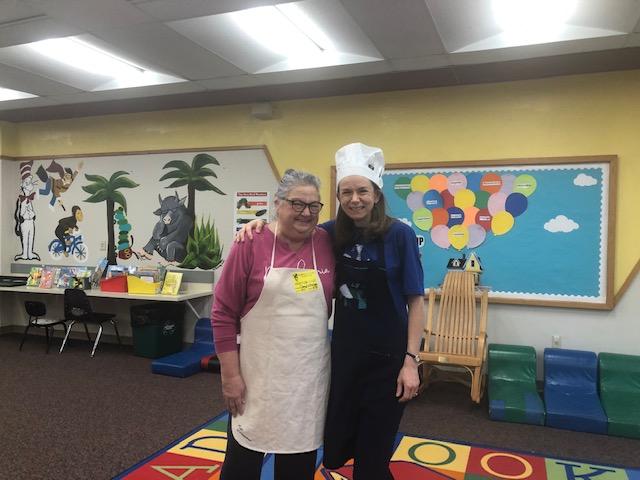 Mrs. Cheryl Witherspoon (grandparent volunteer) and Mrs. Ruth Panuccio (library aide) were the 'chefs' at the 'restaurant'
