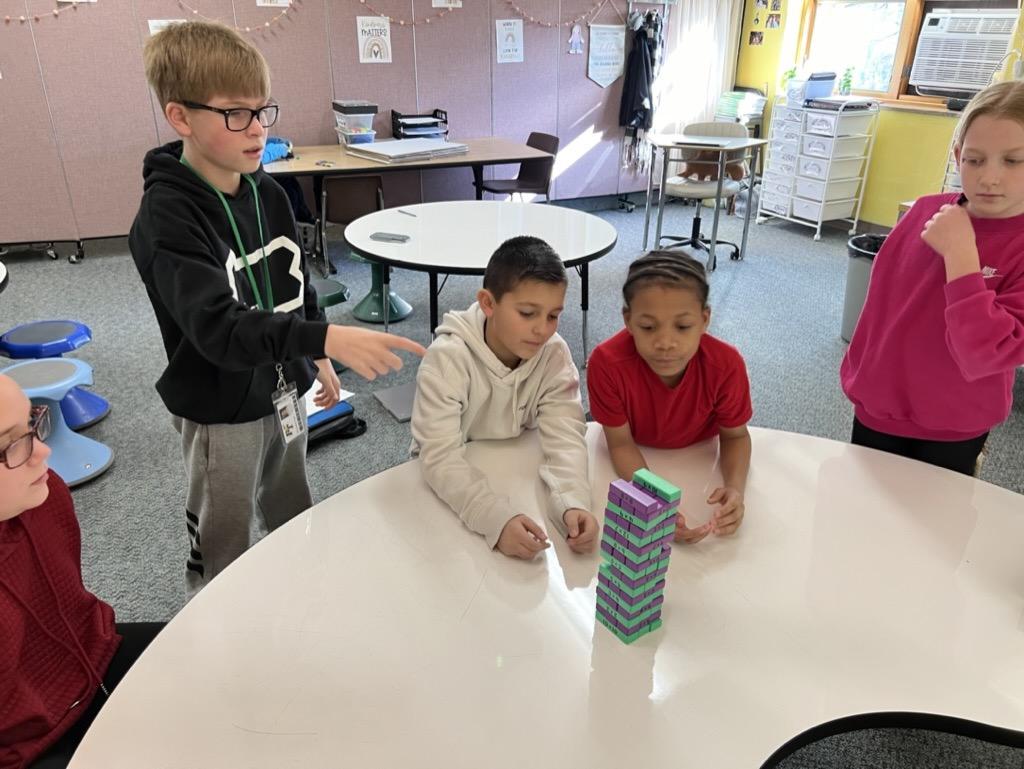 5th-graders Brookson Yost, Wyatt Pushinsky, Zyon Bethea-Knox, and Liliana McDonald play Multiplication Jenga